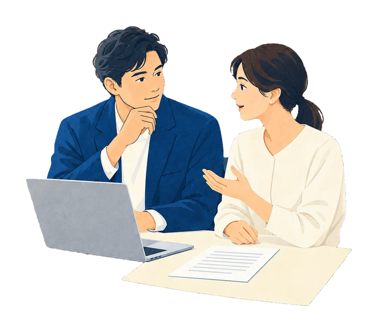 机の上のPCと資料を見ながら、採用について話し合う二人